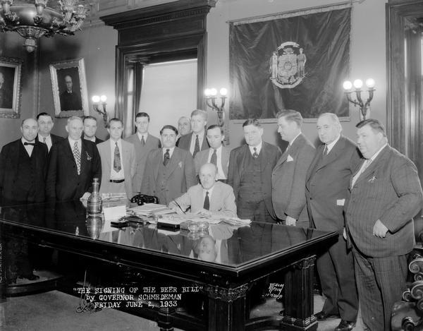 Governor Albert G. Schmedeman signing the Beer Bill with 14 men observing.