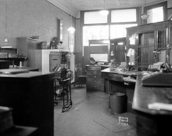 Interior view from behind teller cages of the Stoughton Bank after robbery.