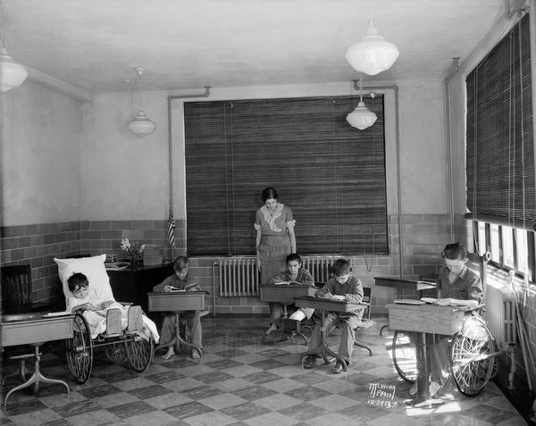 Students seated at desks at Wisconsin Orthopedic Hospital for Children, University of Wisconsin, 436 North Randall Street.