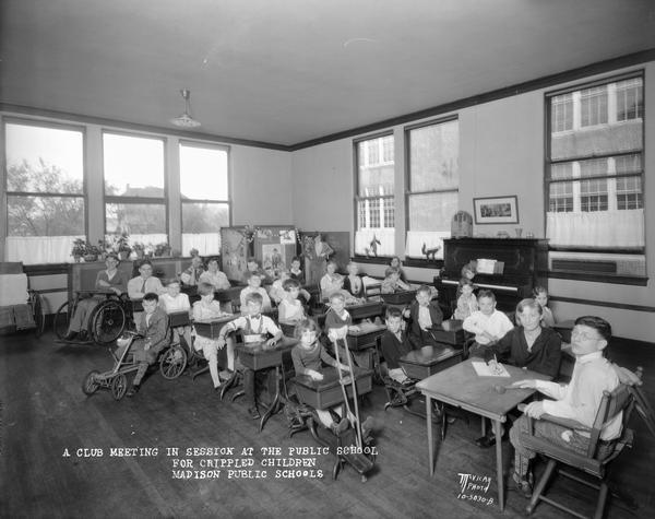 Disabled students with crutches, wheelchairs and other aids for locomotion holding a club meeting at Longfellow School in the Greenbush neighborhood.