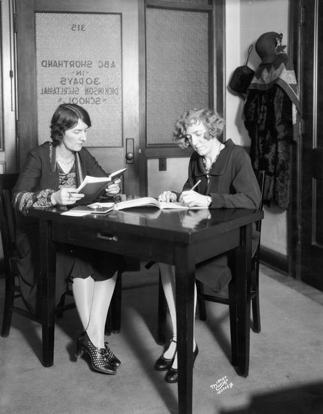 A women dictates to another student practicing for ABC shorthand at the Dickinson Secretarial School, 105 Monona Avenue.