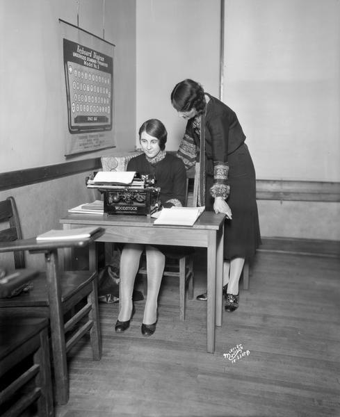 Mrs. Florence J. Blumer, standing, giving individual instruction in typewriting on a Woodstock typewriter to Miss Letha Luchsinger, of Belleville, a student at the Dickinson Secretarial School, 105 Monona Avenue.