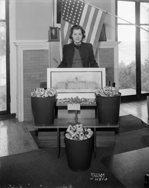 Ruth Ryan, bond secretary of C.U.N.A., Credit Union National Association, with empty bank cans and money.