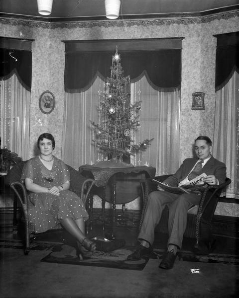 William "Bing" and Florence Crapser Florence and William "Bing" Crapser sitting beside their Christmas tree, 139 North Lake Street.