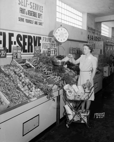 A woman shopping in the produce department at the Kroger store at Union Corners, 2541 Winnebago Street. She was promoting the Oscar Mayer Health for Victory Club.