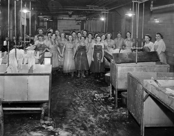 Group portrait of female workers in the casing department of Oscar Mayer & Company, located at 910 Mayer Avenue.