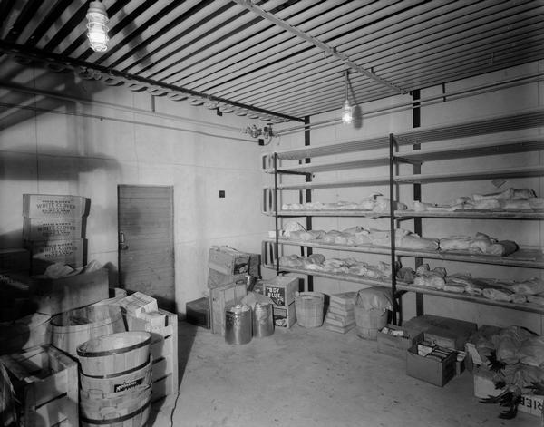 Freezer room at 20th Century Market, 1860 East Washington Avenue, with Oscar Mayer's White Clover brand pure lard and other products on the floor and shelves.