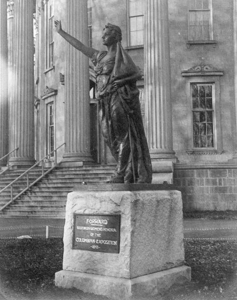 "Forward", the statue created by Jean Pond Miner of Wisconsin for the Wisconsin Women's Memorial at the Columbian Exposition in 1893. The statue is seen on the grounds of the third Wisconsin State Capitol. Behind the statue can be seen the swans neck ornamentation used on all first floor windows.