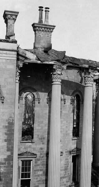 Damaged East Wing of the third Wisconsin State Capitol after the fire of February 27-28, showing details of the iron Corinthian columns, and the decoration of the windows and chimneys.