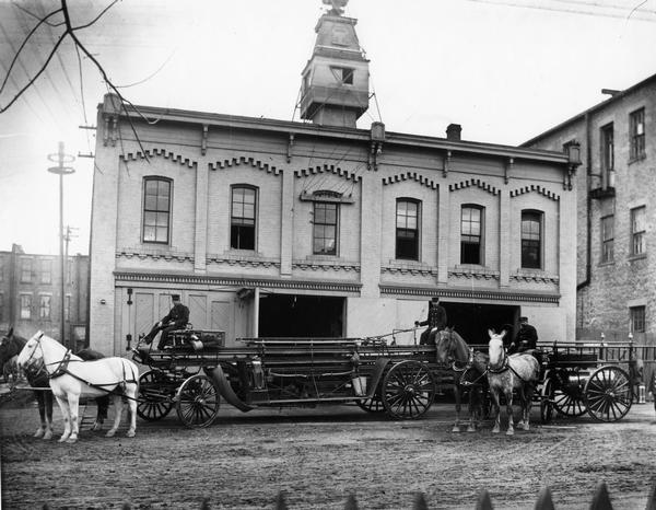 Madison's old Central Fire Station (1881-1904), 10 South Webster Street, with two ladder wagons pictured in front of the station. The wagon on the left is the William H. Rogers Hook & Ladder Company, as the Capitol Hook & Ladder Company was known after its incorporation into the city fire department in 1885. This building was originally the Billings Plow Works and then became the Police Garage. Later it became the Little Printing Co. after the fire department moved out.