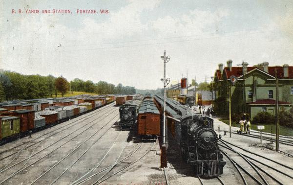 Elevated view of the railroad yards and station. Caption reads: "R. R. Yards and Station, Portage, Wis."