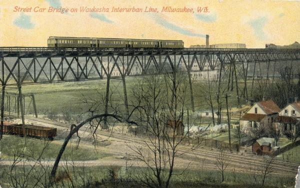 Elevated view across valley toward a streetcar viaduct on the Waukesha Interurban Line, near Milwaukee. Caption reads: "Street Car Bridge on Waukesha Interurban Line, Milwaukee, Wis."