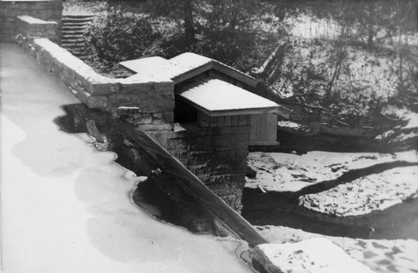 The hydro house and dam at Taliesin, summer residence of Frank Lloyd Wright and the Taliesin Fellowship covered with snow. The hydro house was designed by Wright. Taliesin is located in the vicinity of Spring Green, Wisconsin.