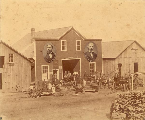 Several people posed among farm implements in front of the machinery and insurance business of Gustav Reinhardt and Charles Pelunek (a.k.a. "Bohemian Charley"). Reinhardt and Pelunek, whose portraits are inset on the facade of the building, ran the business at 204 South Main Street in Alma, Wisconsin together from 1779-1882. (Information from Alma On the Mississippi by Barbara Anderson-Sannes.)