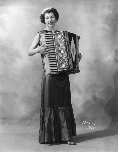 Darlene Quinn, a student at the Kehl School, poses with an accordion.