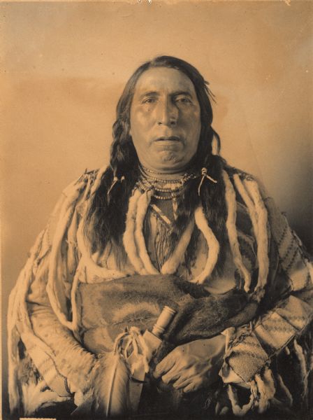 Portrait (Front) of Ne-sort-scinna, called Four Horns, in partial native dress with ornament. Part of Siouan (Sioux) and Blackfoot Tribes.