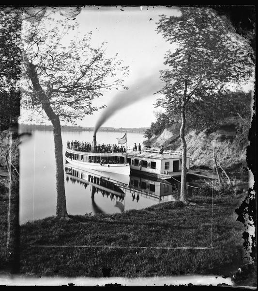 Norwegian Sunday School Picnic at Mendota steamboat landing. Small lake steamer "Mendota" could reach speeds of up to 18 mph. The barge "Uncle Sam" was 75ft long by 25ft, and was either towed about the lake or anchored at the picnic grounds at McBrides Point. "The Mendota" made regular trips to Picnic Point, the University, Pheasant Branch, and the Insane Asylum.