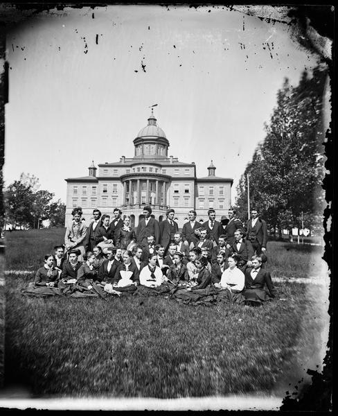 The University of Wisconsin Class of 1876 on the lawn in front of Main Hall (later Bascom Hall). Prominent members of the class included Richard B. Dudgeon (back row, second from the left), who would become Madison's superintendent of schools, his sister Emma Dudgeon (back row, third from the left), who would become a teacher at Longfellow School in Madison, and Helen Remington (front row, sixth woman from the left), who would become the head of the Wisconsin Woman's Suffrage Association and wife of John Olin.