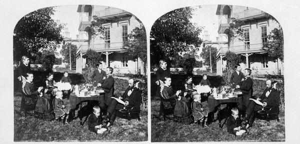 F.A. Schmidt, professor of theology at the Norwegian Lutheran Seminary, with his family on the grounds of the seminary, formerly the Soldiers' and Orphans' home.