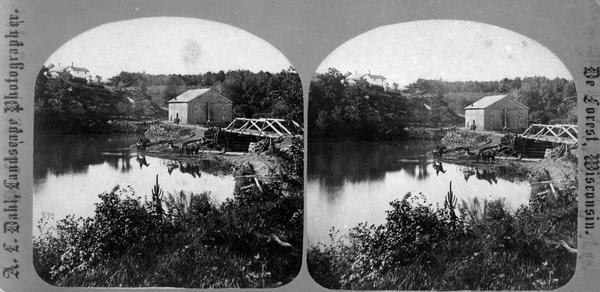 View of a bridge, dam and mill. Moscow was platted in 1850 by an Englishman, Chauncy Smith, who dammed the Bluemound branch of the Pecatonica River to run a grist mill. It was settled by English, Irish, German and Norwegian immigrants.