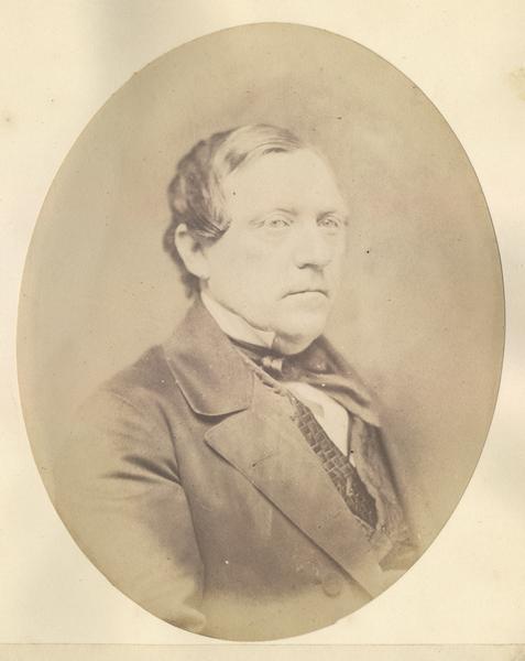 Quarter-length oval portrait of Josiah A. Noonan.  He was born in Amsterdam, Montgomery County, New York.  Noonan came to Wisconsin in November of 1836.  He became publisher of the Mohawk Courier and Little Falls Gazette in 1834.  Later, he moved to Milwaukee where he was elected postmaster in 1843.  He went on to become a partner in a paper mill, open a paper warehouse, and establish the Northwestern Type Foundry.