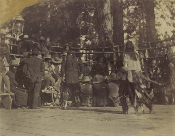 Indian dancers on a platform, with drummers in the rear, at the Warm Springs Agency in Oregon.