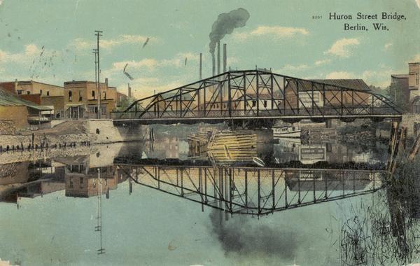 View across water towards the Huron Street bridge. Caption reads: "Huron Street Bridge, Berlin, Wis."