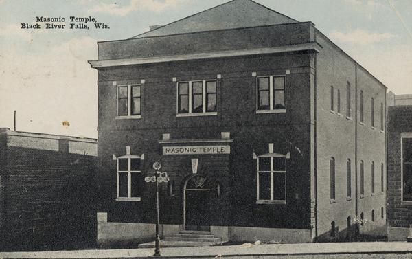 View from street towards front and right side of the Masonic Temple. Caption reads: "Masonic Temple, Black River Falls, Wis."