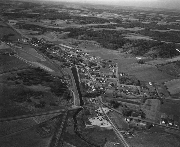 Aerial view of Cross Plains, with countryside surrounding and hills on the horizon.