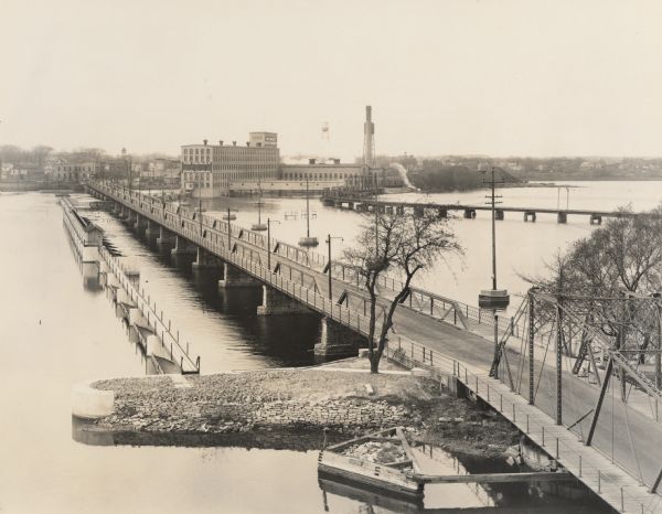 Elevated view of the bridge over the Fox river, and the Nicolet Paper Company on the far shoreline.
