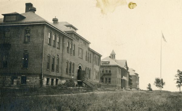 View of the Hayward Indian School, including the boys' building, chapel and schoolrooms, and the girls' building.