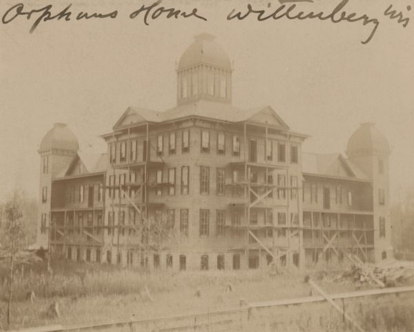 The multi-storied Orphans' Home in Wittenberg. Handwriting on front reads: "Orphans Home Wittenberg Wis".