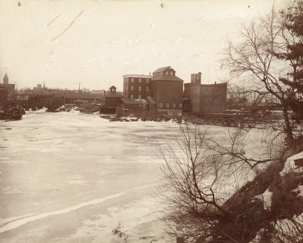 View from bank of river towards the Cereal Mills Company, looking North toward Big Bull Falls.