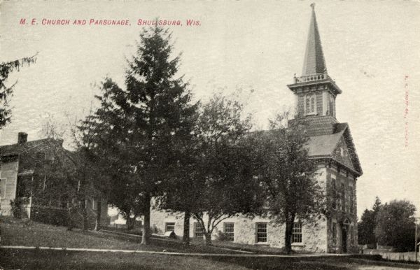 Exterior view of the Centenary Methodist Episcopal Church and parsonage, built in 1867. Caption reads: "M.E. Church and Parsonage, Shullsburg, Wis."