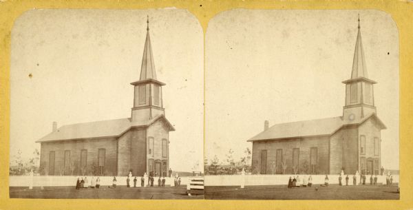 Stereograph view of a Methodist Episcopal church with children and adults lined up outside the fence.
