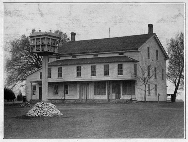 View of Leonard Martin's Tavern in Chamberlain, with large Martin house in front.
