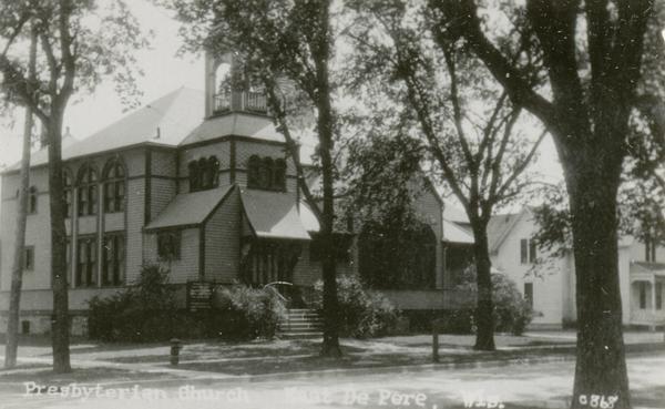 Caption reads: Presbyterian Church East De Pere." View from street of the church on a corner.