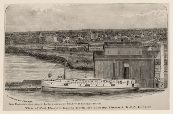 Elevated view showing Elmore and Kelly's Elevator with a boat, train, and the buildings at Fort Howard. Fort Howard was incorporated into Green Bay. Caption reads: "View of Fort Howard, looking North and showing Elmore & Kelly's Elevator."