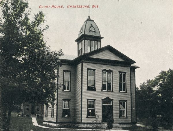 Exterior of courthouse with trees. Caption reads: "Court House, Grantsburg, Wis."