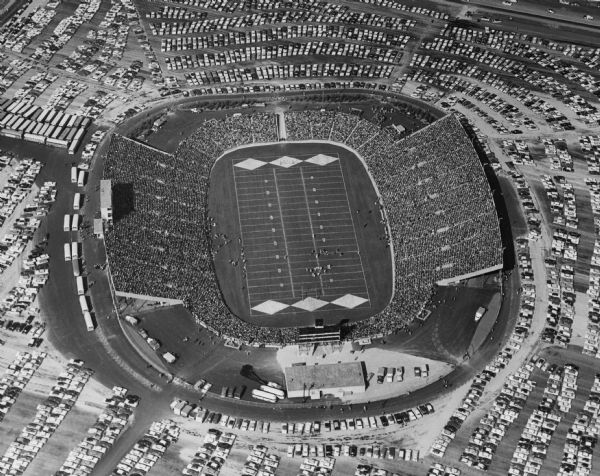 Aerial view of Lambeau Field (known as City Stadium from 1957 to 1965), home the Green Bay Packers football team, with a full parking lot. The capacity of the stadium at the time of this photograph was over 50,000.