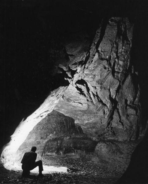 Norb Bybee shoots a self-portrait with his camera of petroglyphs that are carved in the face of a rock shelter near Gullikson's Glen.