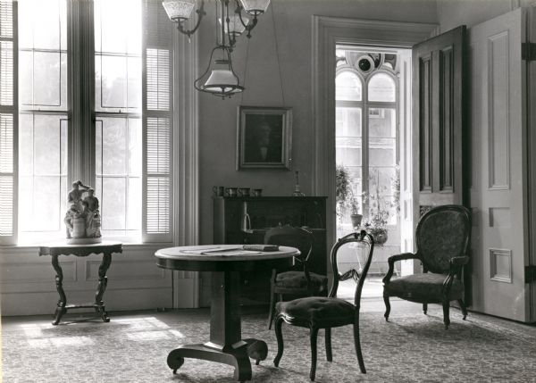 View of the second parlor in the Tallman House. On the right is the open doorway to the conservatory.