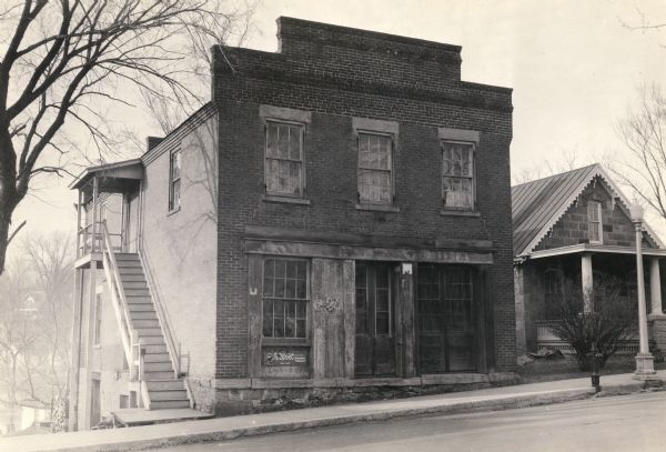 View from across street of the Washburn and Woodman Bank building, erected by C.C. Washburn and Cyrus Woodman. The bank was established in 1846 and operated until 1855.