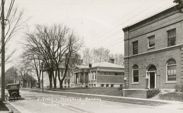 Exterior of the Public Library and Telephone Company buildings in Monroe. Caption reads: "Library and Telephone Building, Monroe, Wis."