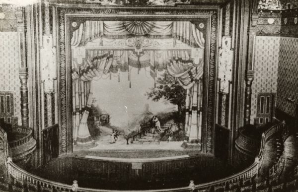 The Oshkosh Grand Opera House. This is the interior elevated view showing the curtain painted by Louis Kindt of Kenosha, which depicts a scene from Goethe's "Herman and Dorthea"; the rest of the decor is by J. Frank Waldo of Oshkosh.