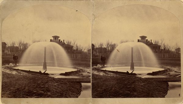 Stereograph of artesian well, located near the intersection of Wisconsin Street and South Minnesota Street (since renamed Wacouta).