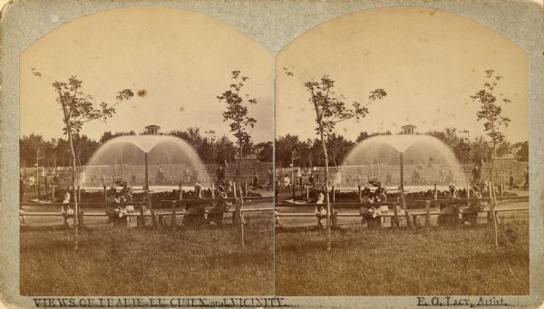 Stereograph of an artesian well, located near the intersection of Wisconsin Street and South Minnesota Street (since renamed Wacouta). Construction was completed in 1876. Caption reads: "View of Prairie Du Chien and Vicinity."
