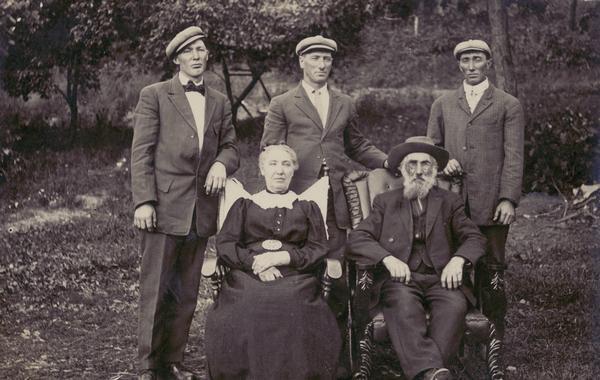 Group portrait of the Olver (Oliver) family. In chairs: Alice Melissa and John Joseph; sons, from left to right standing: Louis Franklin (Frank), Willard Slyvester, and John Henry.