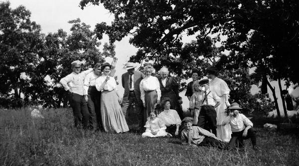 A gathering of La Follette family and friends at Maple Bluff Farm.  From the left they are Senator Robert M. La Follette, Sr.; Gilbert and Netha Roe; Robert Siebecker; Josie La Follette Siebecker; Aunt Belle; Flora Siebecker; Fola La Follette; Belle Case La Follette; Robert M. La Follette, Jr.; Mary and Philip La Follette, and two individuals identified only as Joe and Nellie D.