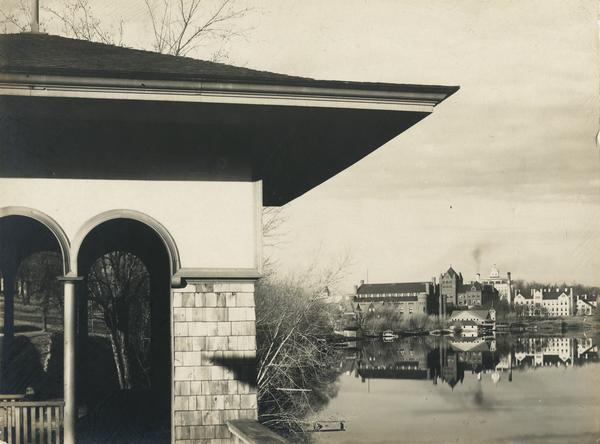 Partial view of a boathouse at the foot of North Carroll Street, designed by Frank Lloyd Wright and built for the city of Madison. The University of Wisconsin-Madison campus is seen in the distance across Lake Mendota.